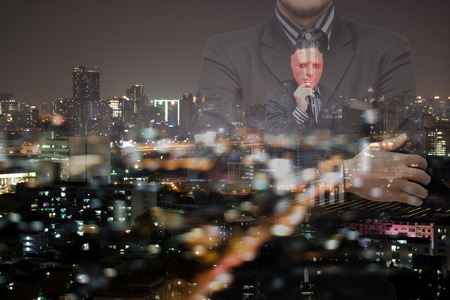 business concept,business man with the mask inside his mind with city at night background with bokehの写真素材