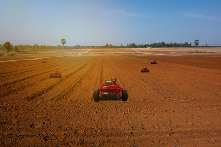 iot, internet of things, agriculture concepts, Farmer use automatic robot assistant to work in the farm , to detect the weed ,spray the chemical use robot for replace worker and increase efficiencyの写真素材