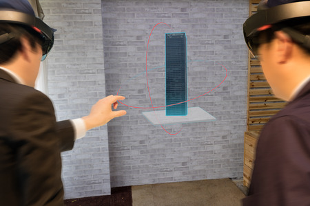 Smart industry technology  concept, civil engineer,architect (blurred) use augmented mixed virtual reality technology to see construction,building for design, analysis,diagnose,process in 3dの写真素材