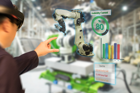 iot industry 4.0 concept,industrial engineer(blurred) using smart glasses with augmented mixed with virtual reality technology to monitoring machine in real time.Smart factory use Automation robot armの写真素材