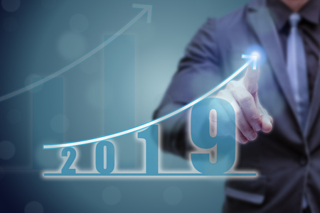 business man point hand on the top of arrow graph with high rate of growth. The success and growing growth graph in the company or industrial after investment in 2019の写真素材