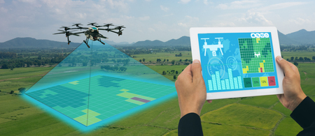 drone for agriculture, drone use for various fields like research analysis, safety,rescue, terrain scanning technology, monitoring soil hydration ,yield problem and send data to smart farmer on tabletの写真素材