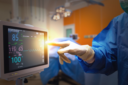 smart medical technology in hospital concept, doctor in Surgeons team field holding medical instruments for surgery the patient in operation roomの写真素材