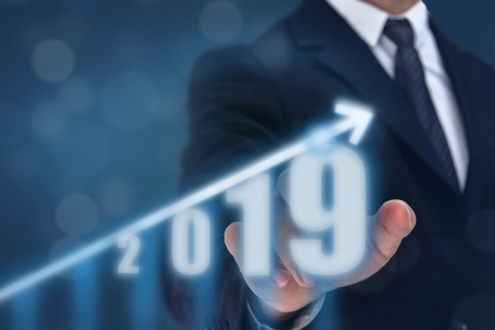 business man point hand on the top of arrow graph with high rate of growth. The success and growing growth graph in the company or industrial after investment in 2019の写真素材