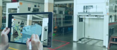 smart manufacturing ,industry 4.0, 5.0 technology concept, man use augmented mixed virtual reality technology to manage and simultion to install new machine in the factory predict, analytic how to fitの写真素材