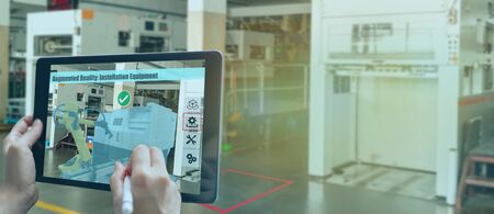smart manufacturing ,industry 4.0, 5.0 technology concept, man use augmented mixed virtual reality technology to manage and simultion to install new machine in the factory predict, analytic how to fitの写真素材