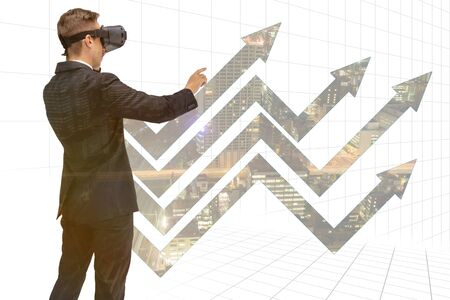 double explosure business man use augmented mixed virtual reality to show the growth graphの写真素材