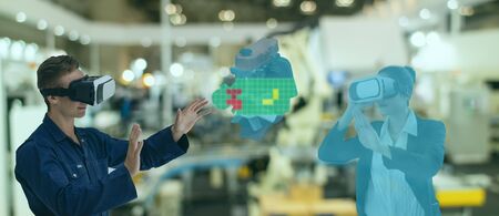 iot industry 4.0 concept,industrial engineer using smart glasses with augmented mixed with virtual reality technology to monitoring machine in real time with hologram of assistant engineer in 3dの写真素材