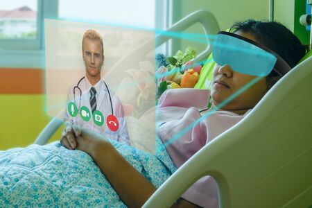 smart technology in hospital concept, the patient use smart glasses with augmented mixed virtual reality technology to meeting online with the doctor to discuss with Patient's symptomsの写真素材