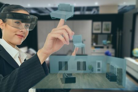 mixed virtual reality concept, woman hold the simulation furniture to decorate the room for management and adjust in the smart retail or furniture store companyの写真素材