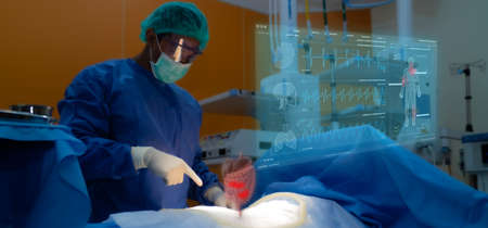 smart medical technology concept, doctor use glasses to use augmented reality to show the injury of stomach of the patient for analysis and find the way to treatment in surgery room at hospitalの写真素材