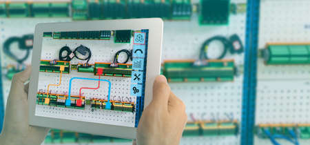 iot smart industry 4.0 concept. Industrial engineer(blurred) using smart glasses with augmented mixed virtual reality technology to read the data that  how to fix or maintenance the machine in factoryの写真素材