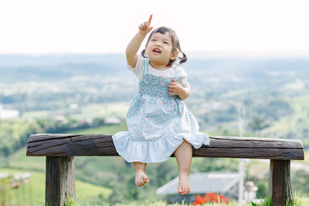 The little girl Running for fun in the garden.の写真素材
