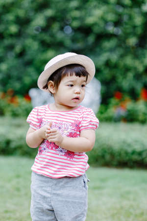 The little girl Running for fun in the garden.の写真素材
