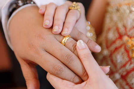 Hand of lover are wearing a ring on her wedding dayの写真素材