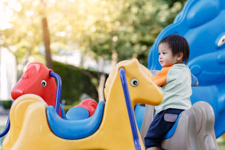 Little boy playing fun at Playground in the afternoonの写真素材