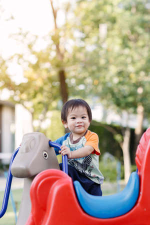 Little boy playing fun at Playground in the afternoonの写真素材