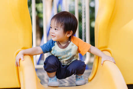 Little boy playing fun at Playground in the afternoonの写真素材