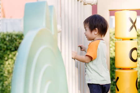 Little boy playing fun at Playground in the afternoonの写真素材