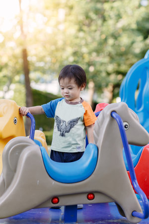 Little boy playing fun at Playground in the afternoonの写真素材