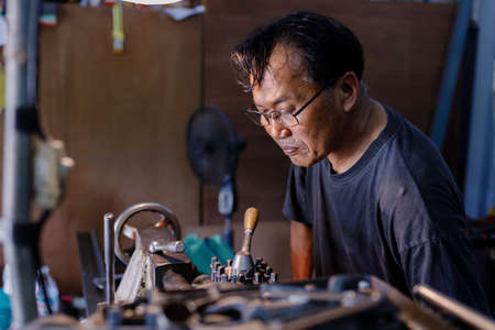 Asians Craftsman being machined steel in a factory.の写真素材