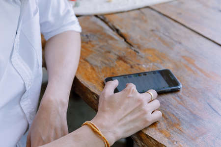 Closeup hand of  Asians man using a mobile phone.の写真素材