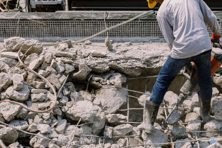 Construction worker  electric drill Drilling concrete ground in construction areaの写真素材