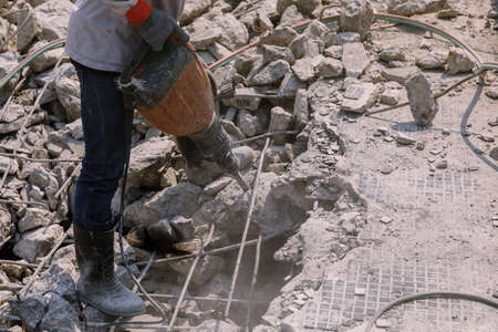 Construction worker  electric drill Drilling concrete ground in construction areaの写真素材
