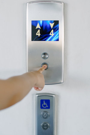 Women are pressing finger down the lift.の写真素材