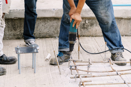 Craftsman are using cement drill floor...