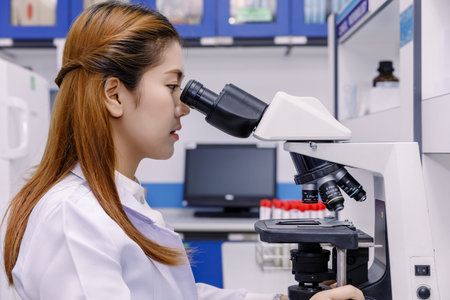 Scientist using a microscope in a laboratory