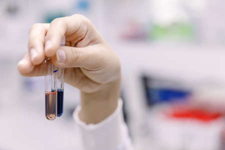 Young Asian researcher looking at the flask in the science laboratory.の写真素材