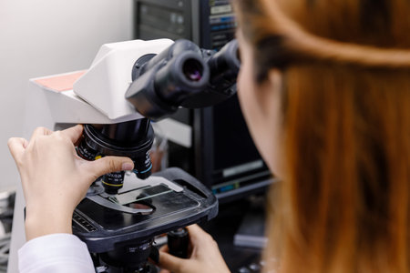 Scientist using a microscope in a laboratoryの写真素材