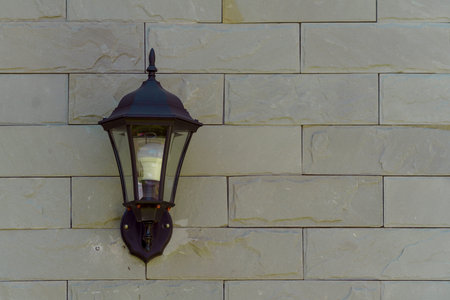 The brown vintage wall lamp on the brick wall