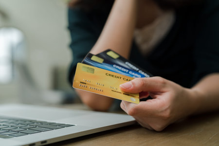 Closeup Asian beautiful woman Wearing a black shirt Sitting in the house Have a credit card in hand...