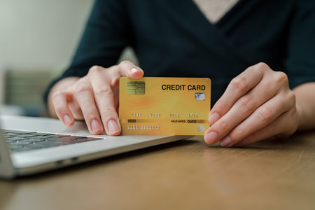 Closeup Asian beautiful woman Wearing a black shirt Sitting in the house Have a credit card in hand...