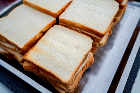 Thin toasted white bread Many are placed in trays ready to eatの写真素材