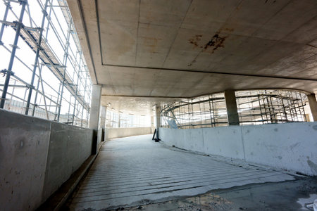 An entranceway to a parking lot that is still under construction in the parking building.