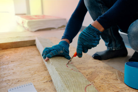 Glove-wearing Asian workers are using a Fire barrier grade clutch to deploy to a construction Zone installation.の写真素材