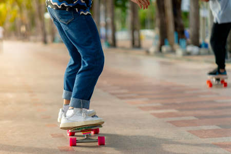 An Asian man's legs are seen standing on a skating surf skating event on the Bangsaen beachfront promenade. Thailandの写真素材