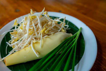 Bean sprouts and banana blossoms, a side dish of Thai food, are placed in a beautifully arranged plate with banana leaves under it.の写真素材