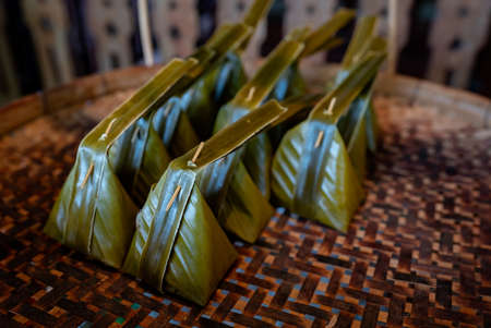 Thailand's most delicious tom knom desserts are made with flour and coconut milk wrapped in banana leaves and placed beautifully.の写真素材