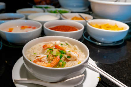 White rice noodles in a ready-to-eat bowl garnished with 3 fresh shrimps.の写真素材