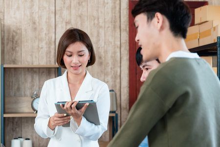 Young LGBTQ Asian Men and women Small Business Partner,The female technician is asking her friends'...