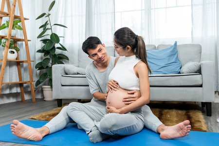 Beautiful Asian mom, sitting with she husband, two them sat looked at belly growing, two pairs of...