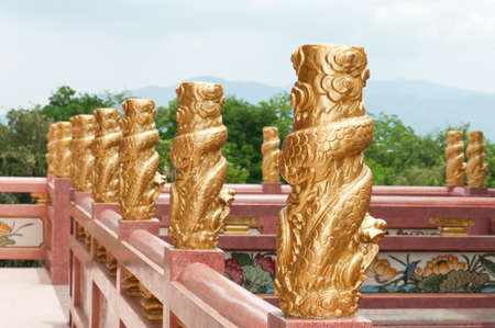 beautiful golden dragon wrapped around the pole in Chinese temple, Thailandの写真素材