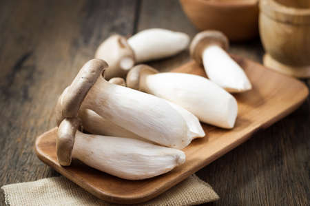 King oyster mushroom, Pleurotus eryngii on wood plateの写真素材
