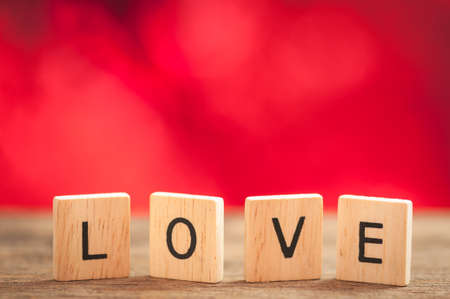 love wooden letters with red background, valentine day concept.の写真素材