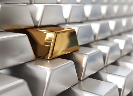 Stack of silver ingots with one goldenの写真素材