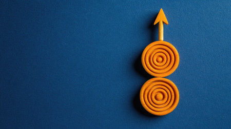 Vibrant orange design featuring concentric circles, arranged vertically against a deep blue background. The concentric circles are layered to create depth and visual interest. The overall design is geometric, abstract, and minimalist, with a focus on color and shape.の素材